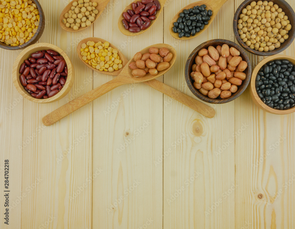 Flat lay,top view assorted beans including red bean,soybeans,black beans,mung beans on brown,beige wooden background with copy space Flat lay,top view assorted beans including red bean,soybeans,black beans,mung beans on brown,beige wooden background with copy space