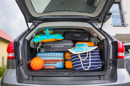 Baggages in the car trunk packed and ready to go for holidays