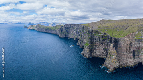 Panoramic aerial view from Sandoy island cliffs under the clouds, Faroe Islands