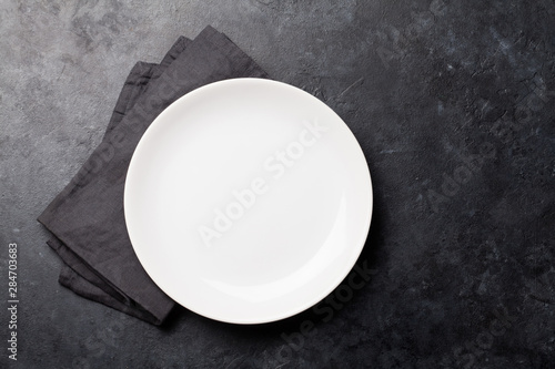 Kitchen table with empty plate and towel