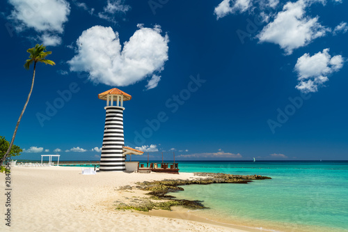Heart shaped cloud over Lighthouse on the beach of the Caribbean, Dominican Republic, Bayahibe - Love Wedding Concept photo