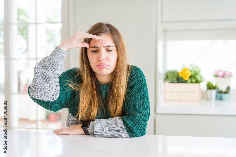 Young beautiful plus size woman wearing casual striped sweater worried and stressed about a problem with hand on forehead, nervous and anxious for crisis Young beautiful plus size woman wearing casual striped sweater worried and stressed about a problem with hand on forehead, nervous and anxious for crisis