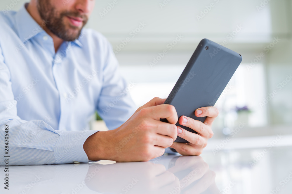Close up of man hands using tablet and smiling Close up of man hands using tablet and smiling