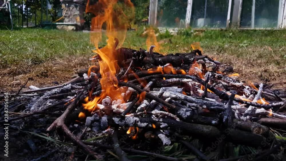 Embers from burning twigs and branches building up heat in the backyard Embers from burning twigs and branches building up heat in the backyard