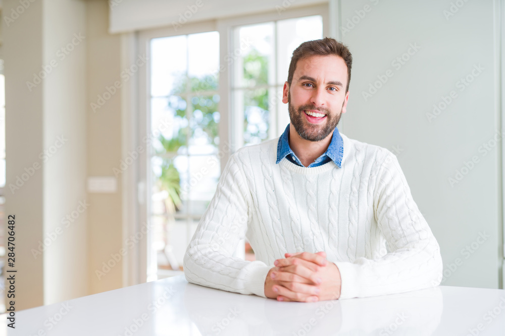 Handsome man smiling positive at the camera