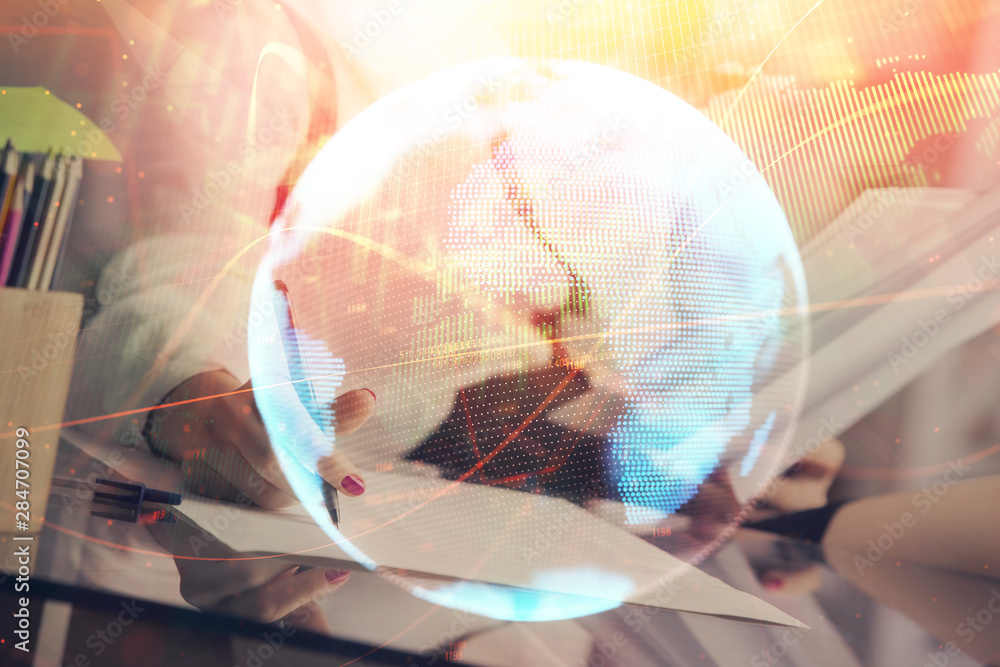 International business hologram over hands taking notes background. Concept of success. Multi exposure International business hologram over hands taking notes background. Concept of success. Multi exposure