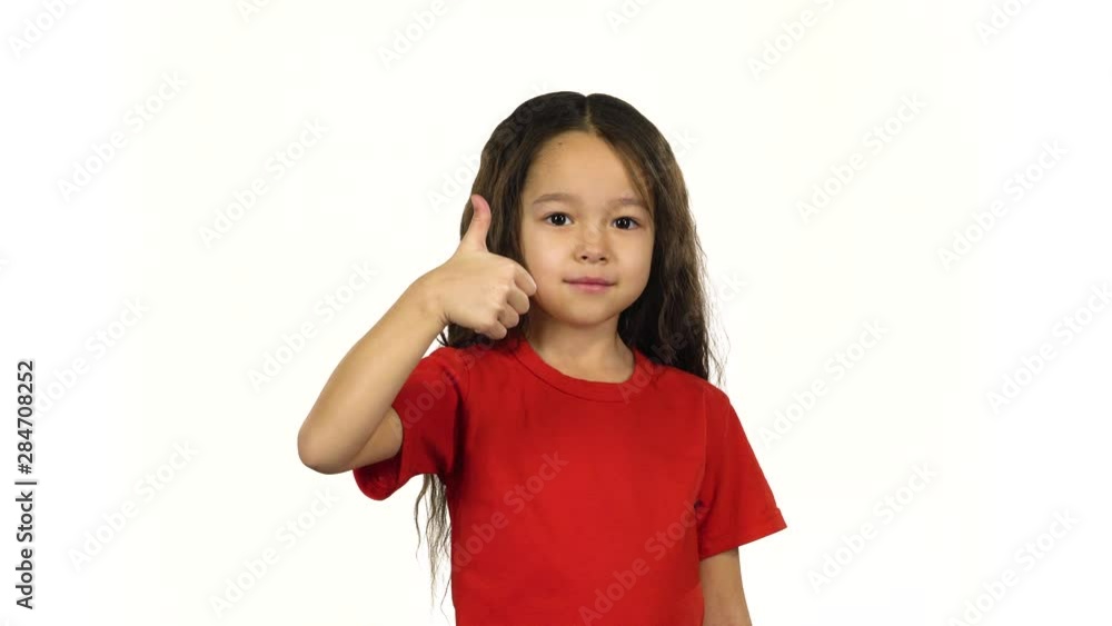 Portrait smart kid showing thumbs up her hands on white background Portrait smart kid showing thumbs up her hands on white background
