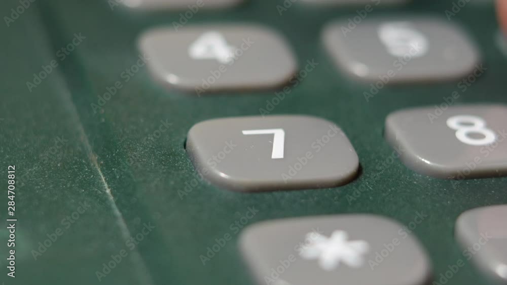 Men's Finger Dials On The Number Seven Button On The A Wired Phone. Men's Finger Dials On The Number Seven Button On The A Wired Phone.