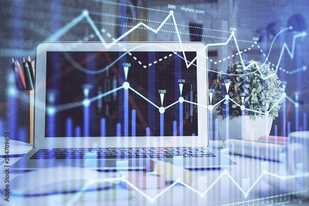 Forex market graph hologram and personal computer on background. Double exposure. Concept of investment. Forex market graph hologram and personal computer on background. Double exposure. Concept of investment.