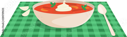 Ukrainian dish borsch in a white plate on a green striped napkin