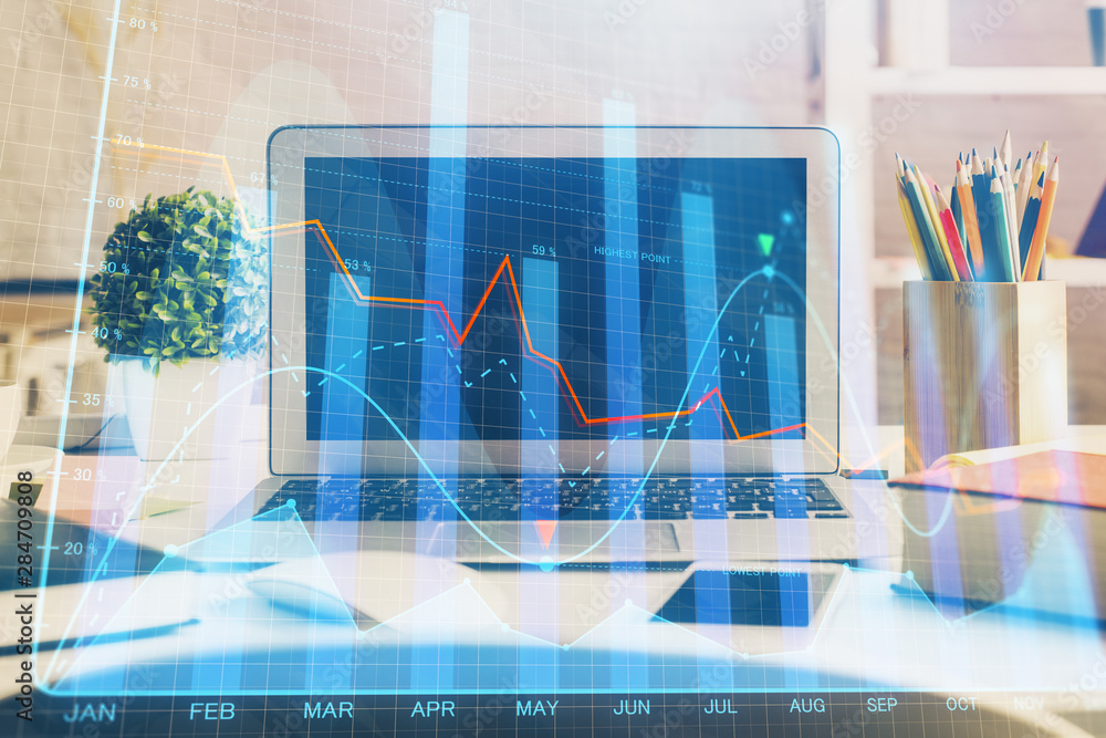 Financial chart drawing and table with computer on background. Multi exposure. Concept of international markets. Financial chart drawing and table with computer on background. Multi exposure. Concept of international markets.