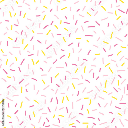 Colorful seamless vector confetti pattern. Bakery themed donut, doughnut or cupcake sugar sprinkle background.