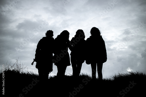  The silhouette of four girls after sunset