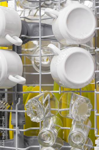 clean kitchen utensils in the dishwasher top view, background close-up