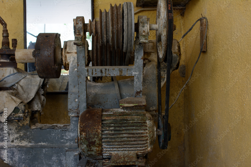 An old mechanical gem processing machine stands under a canopy. Concept - onyx mining and processing An old mechanical gem processing machine stands under a canopy. Concept - onyx mining and processing