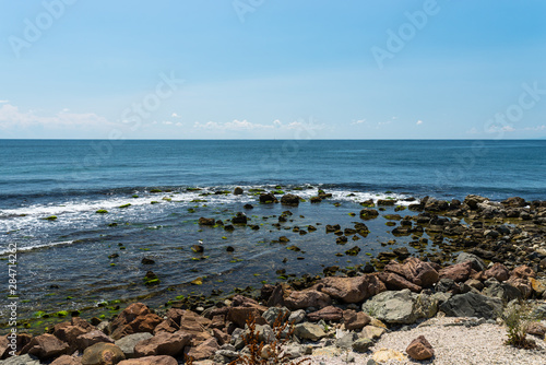 Rocky shore over the beautiful Black Sea, in Nessebar, Bulgaria. In the background a sky with clouds.