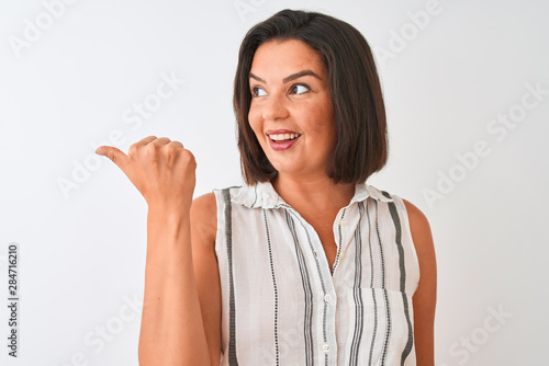 Wallpaper Mural Young beautiful woman wearing casual striped shirt standing over isolated white background pointing and showing with thumb up to the side with happy face smiling Torontodigital.ca