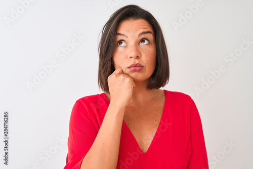 Young beautiful woman wearing red t-shirt standing over isolated white background serious face thinking about question, very confused idea