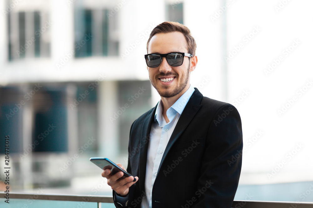 Young guy in glasses and suit talking on the phone and looking up. Young guy in glasses and suit talking on the phone and looking up.