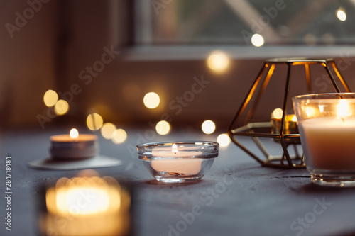 Candles on windowsill, close-up. Hygge background