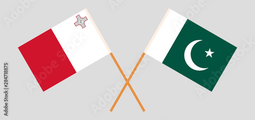 Pakistan and Malta. Crossed Pakistani and Maltese flags photo