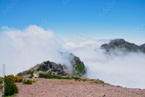 Landscape of hiking trail from Pico do Arieiro to Pico Ruivo, Madeira island, Portugal in summy summer day above the clouds photo