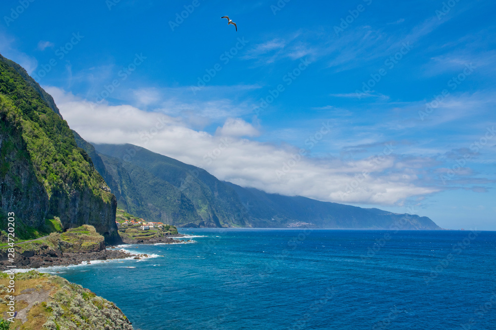Best panoramic adorable view blue water and blue sky viewpoint on Madeira island in Atlantic ocean view from Sao Vicente and Ponta Delgada to Porto Moniz in summer sunny day, Madeira island, Portugal 