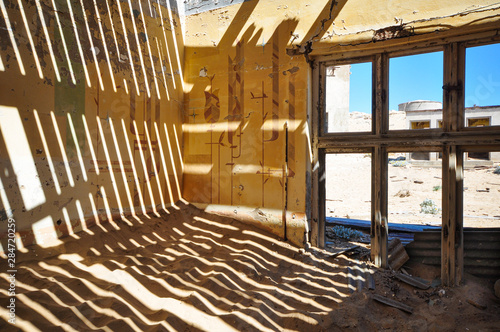 Inside an abandoned house in the mining ghost town of Kolmanskop in Namibia