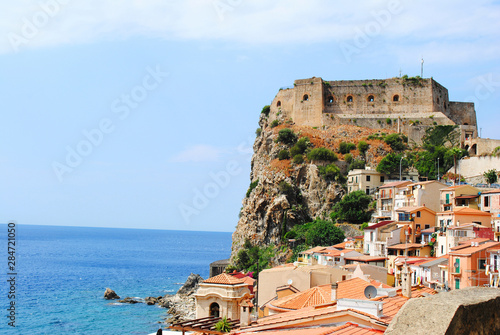 Seaside town Scilla with castle on rock Castello Ruffo. Mediterranean Tyrrhenian sea coast. Scilla, Calabria, Italy. July 2019