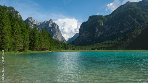 View of Dobbiaco Lake and surrounding mountains. Dolomites, Italy