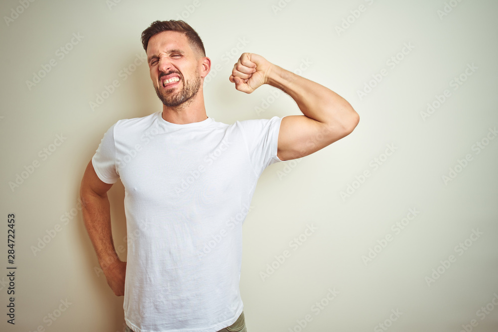 Young handsome man wearing casual white t-shirt over isolated background stretching back, tired and relaxed, sleepy and yawning for early morning Young handsome man wearing casual white t-shirt over isolated background stretching back, tired and relaxed, sleepy and yawning for early morning