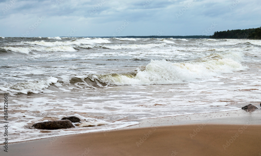 Fototapeta premium beautiful waves going to the coast, stormy sea with thunder clouds over,