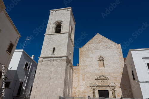 Polignano a Mare, mother church of S. Maria Assunta.  It rises in piazza V. Emanuele and the sober Romanesque facade is embellished on the portal with decorations of 1628. photo