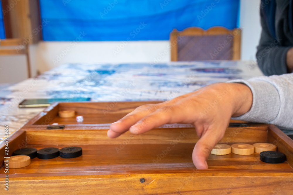 Playing backgammon on a wooden table with dices. Playing backgammon on a wooden table with dices.