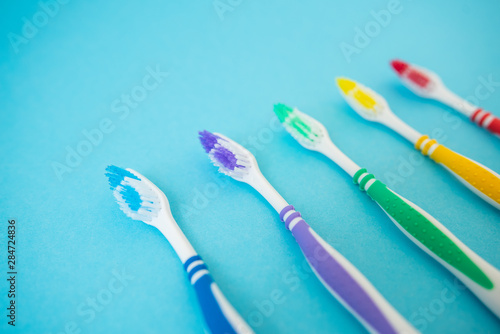 set of plastic toothbrushes on blue background