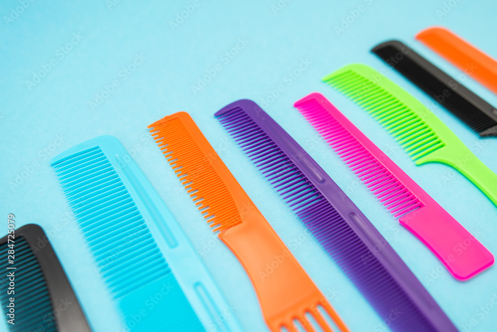 Plastic combs isolated on blue background