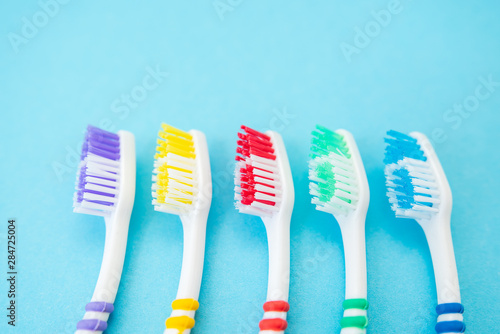 set of plastic toothbrushes on blue background