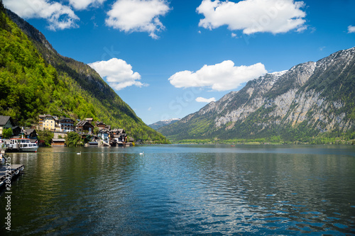 Village is located on the green slopes near lake.