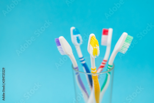 set of plastic toothbrushes on blue background