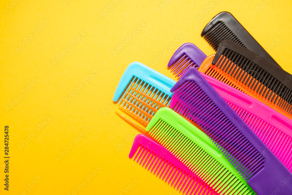 Plastic combs isolated on yellow background