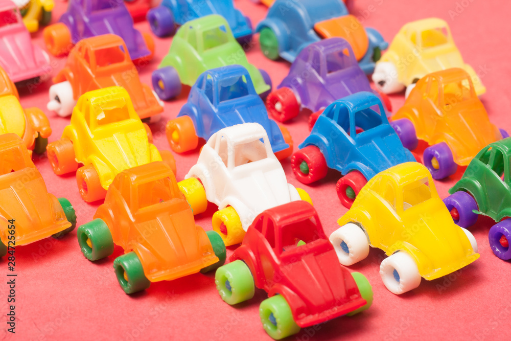 Naklejka premium Toys plastic cars on a red background