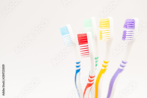 set of plastic toothbrushes on white background