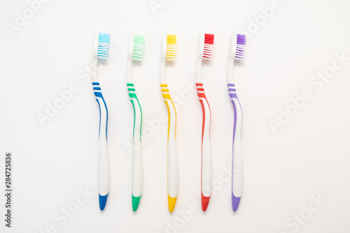 set of plastic toothbrushes on white background