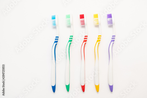 set of plastic toothbrushes on white background