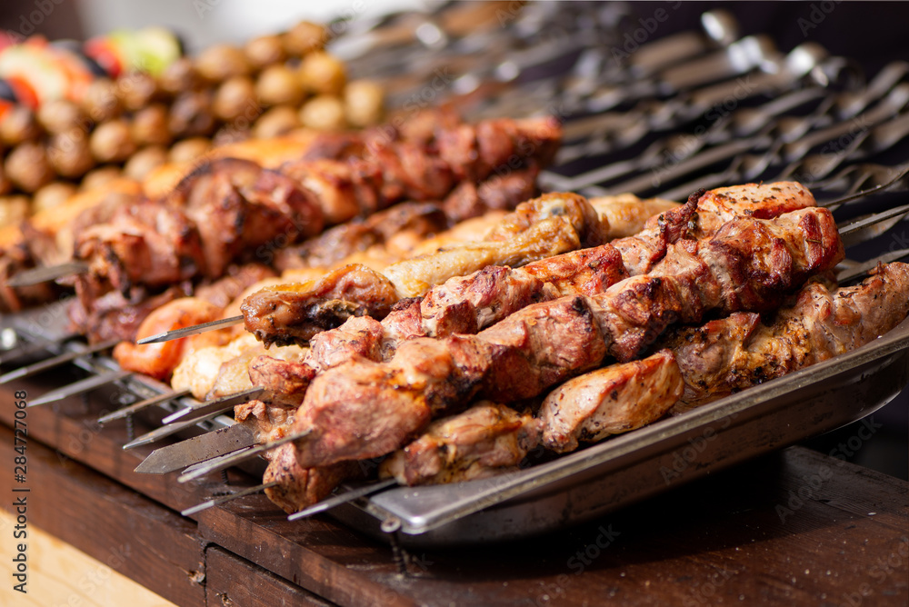 Barbecue grilled meat with onion on metal skewers in the chargrill