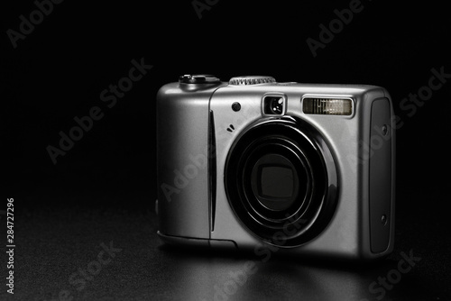 Compact amateur digital camera on black background
