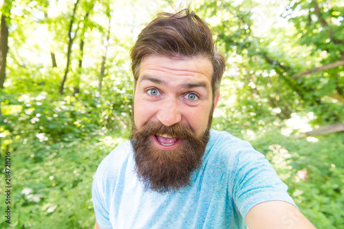 Go wild. Hair care male beauty. Summer fun. Bearded guy in park forest. Bearded hipster. Crazy bearded man in natural environment. Hipster with long beard emotional face close up nature background © be free