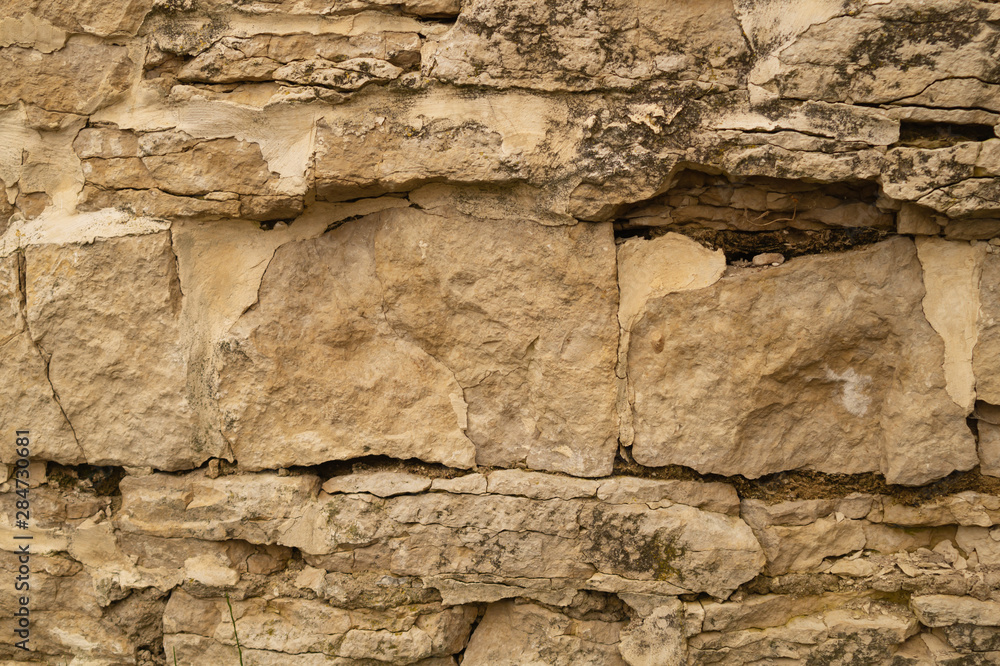 Rocky brick wall. stone wall background. abstract grunge texture. old brown masonry Rocky brick wall. stone wall background. abstract grunge texture. old brown masonry