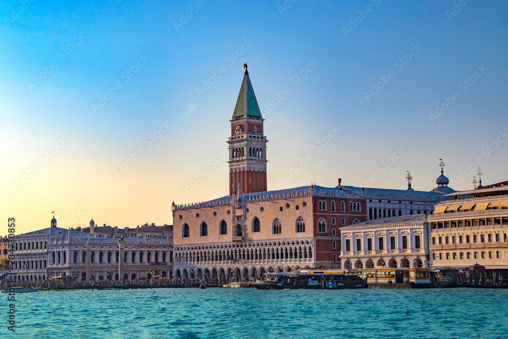 The magnificent view of Venice at sunset in Italy. There are blue sky and clear water.
