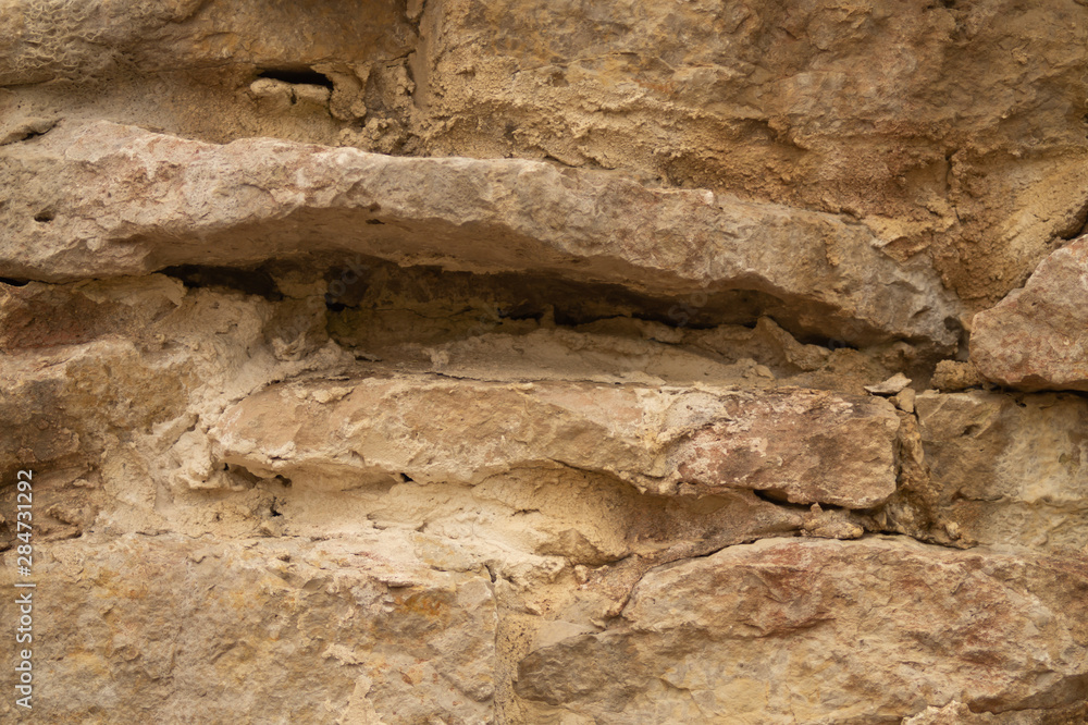 Rocky brick wall. stone wall background. abstract grunge texture. old brown masonry Rocky brick wall. stone wall background. abstract grunge texture. old brown masonry